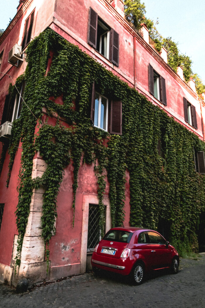 Red Fiat Beside Building Photographic Print Poster