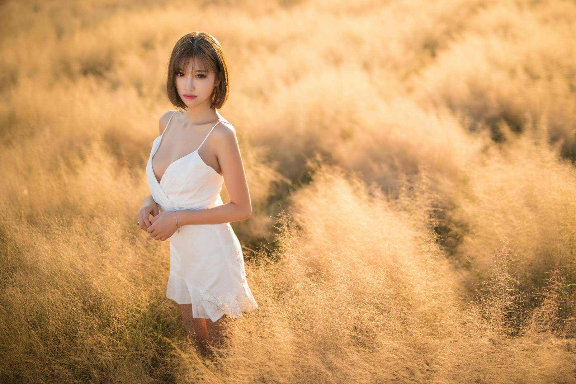 Sensual Asian woman in grassy summer field, soft sunlight, fine art photography print