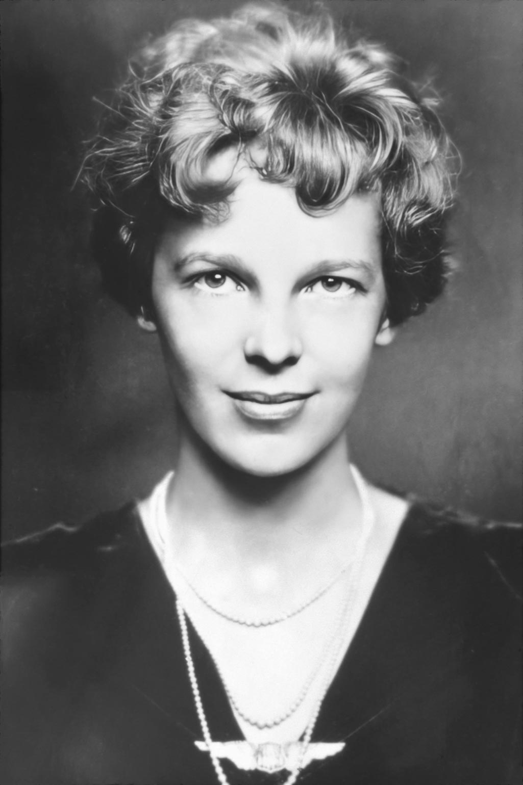Vintage photo poster of Amelia Earhart, the aviation pioneer, wearing 1930s evening clothes