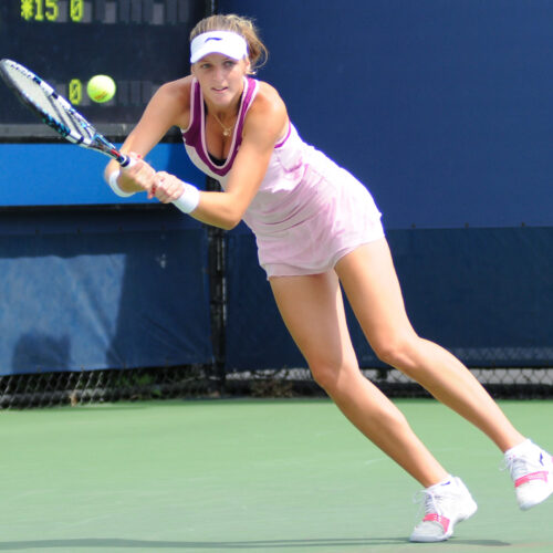 Kristýna Plíšková returning a tennis shot during a professional match, photographed by Christian Mesiano.