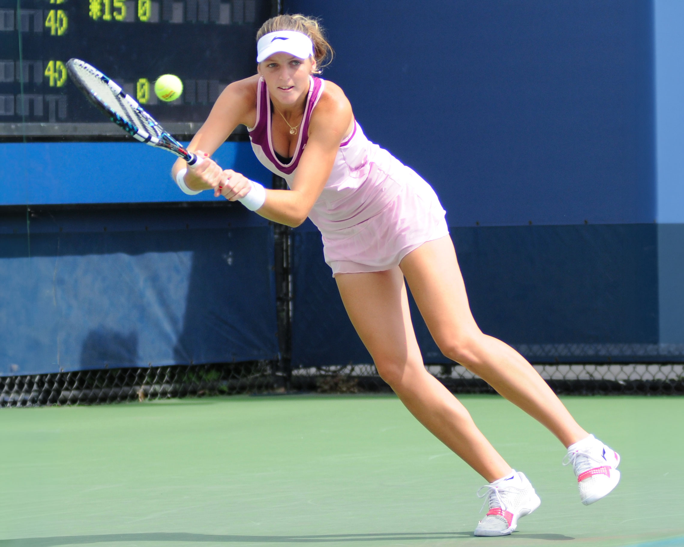 Kristýna Plíšková returning a tennis shot during a professional match, photographed by Christian Mesiano.