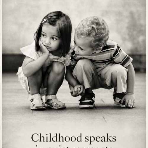 Black and white poster of two young children crouching together in a quiet moment, with the quote “Childhood speaks in quiet moments.”