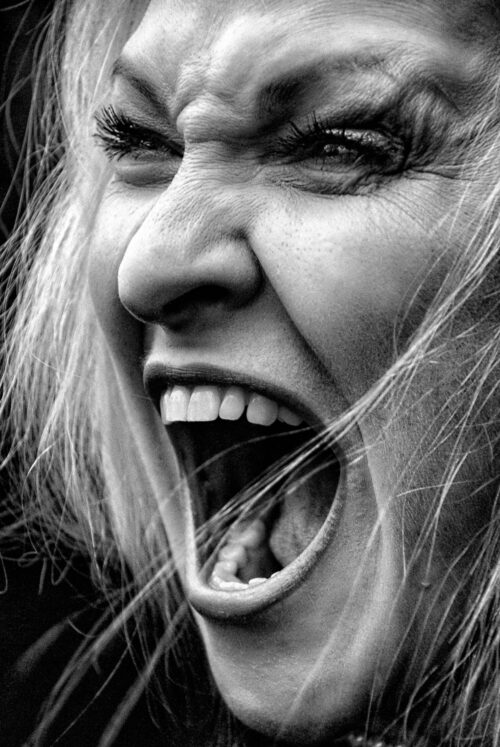 Raw Emotion Portrait – Screaming Woman in High Contrast B&W picture