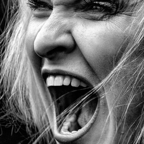 Raw Emotion Portrait – Screaming Woman in High Contrast B&W picture