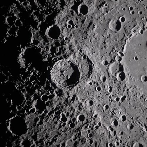 Close-up photographic wall art of the moon surface featuring detailed craters and dramatic high-contrast shadows.