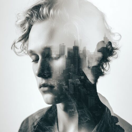 Surrealist double exposure wall art merging a contemplative face with urban city skyline in soft grayscale tones.