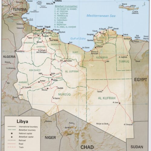 Political map of Libya showing international boundaries, Baladiyah municipalities, cities, roads, and neighboring countries including Tunisia, Algeria, Niger, Chad, Sudan, and Egypt.
