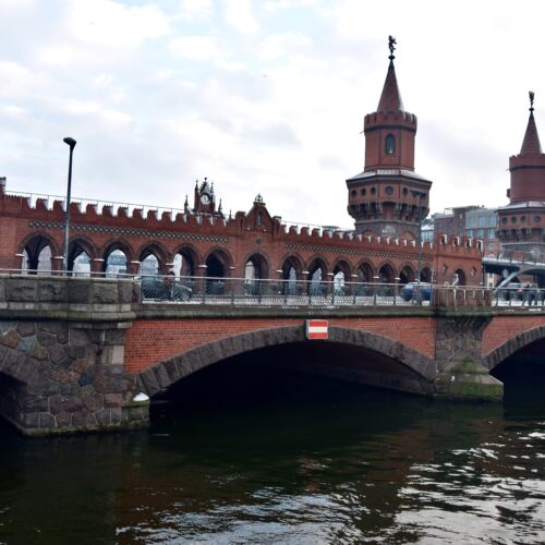 Photographic print of the Oberbaumbrücke, Berlin's iconic red brick bridge with twin neo-Gothic towers spanning the Spree River.