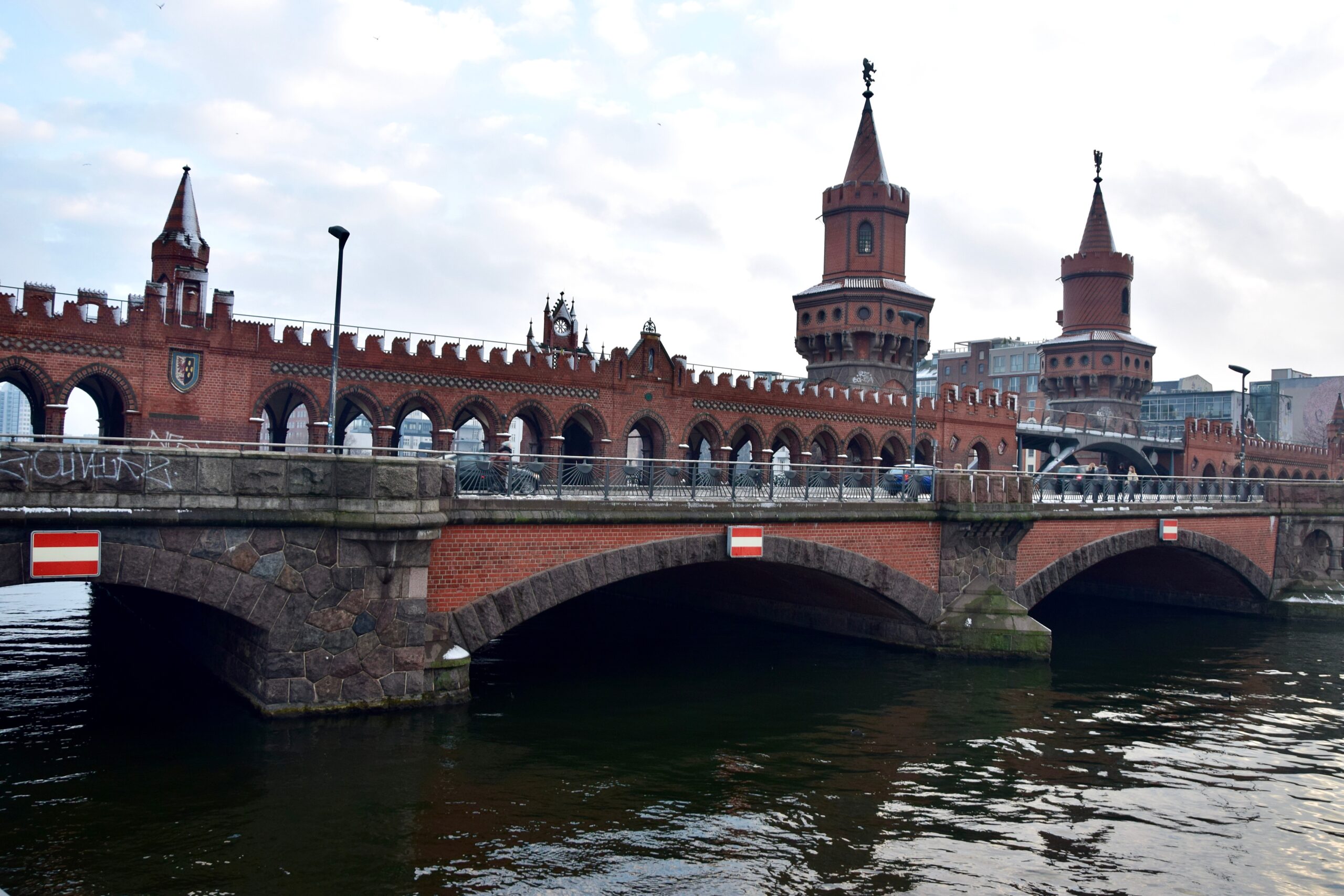 Photographic print of the Oberbaumbrücke, Berlin's iconic red brick bridge with twin neo-Gothic towers spanning the Spree River.