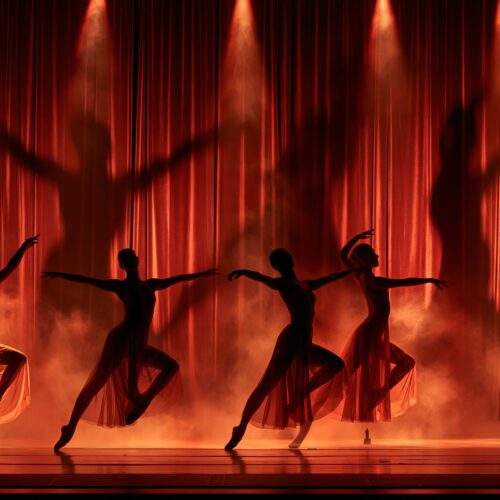 Silhouette of five ballet dancers performing on stage with dramatic red and orange lighting and flowing skirts against a theatrical curtain backdrop.