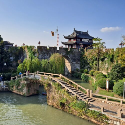 Photographic wall art of Pan Gate in Suzhou, China—historic stone city wall with traditional pavilion, arched bridge, weeping willows, and serene waterway.