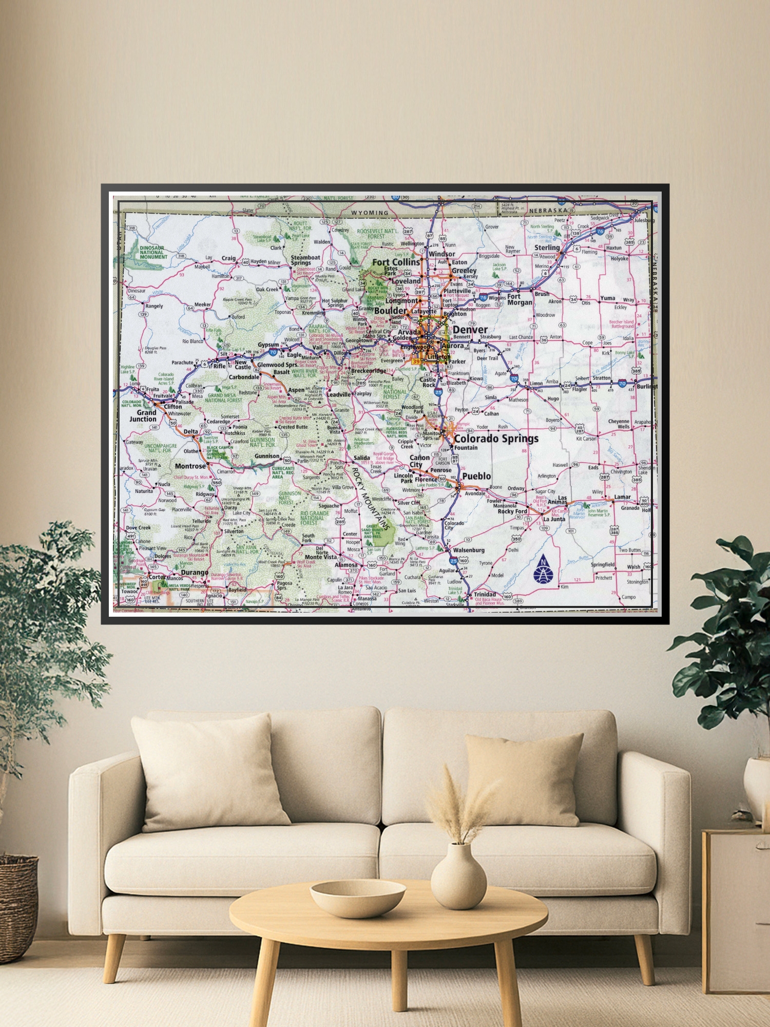 Detailed road map of Colorado showing highways, cities, mountains, national forests, and landmarks in classic cartographic style with pink and green coloring.