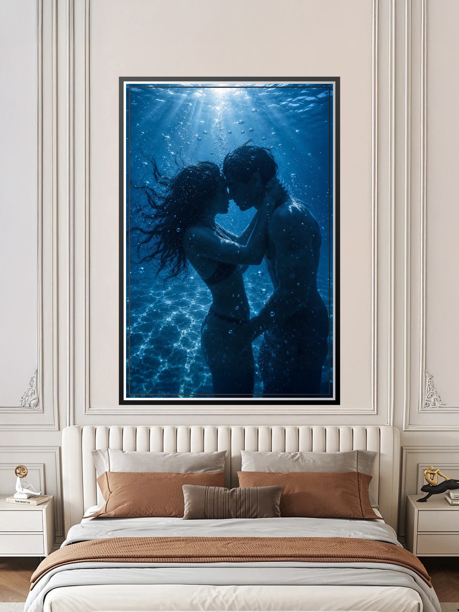 Two silhouetted figures embracing underwater surrounded by shimmering sunlight rays and bubbles against deep blue ocean background.
