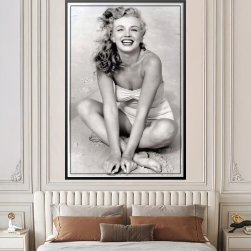 Black and white 1949 vintage portrait of young Marilyn Monroe on Toby Beach by photographer Andre De Dienes, smiling radiantly in classic Hollywood pose.